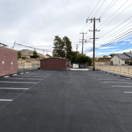 a newly serviced parking lot with seal coating and crack filling method